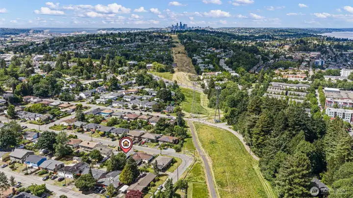 The Chief Sealth Trail runs north from here to Jefferson Park. Seattle skyline straight ahead.