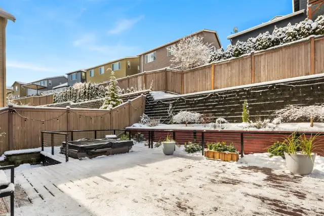 Huge custom Trex Deck w/cable railings, built in hot tub, stairs to left turf side yard, sheer descent waterfall in wall