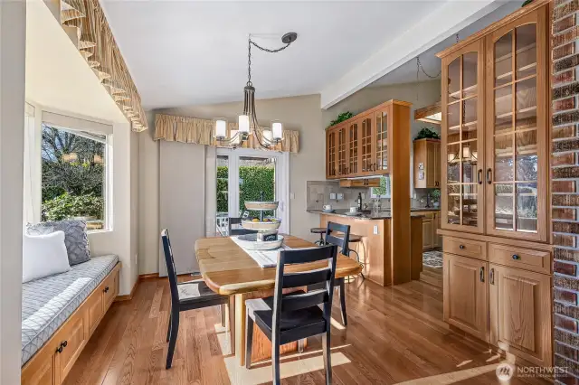 The dining room caters effortlessly to both formal dinners and casual meals, featuring a warm ambiance, built-in window seating, elegant glass-front cabinetry, and an unbelievable mountain view.