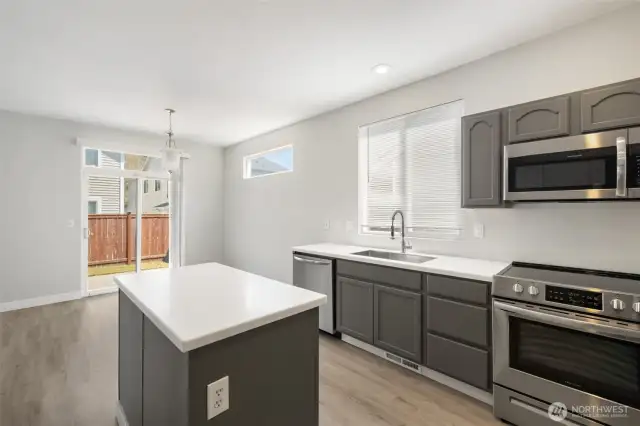 Kitchen and dining area with slider to fenced back yard