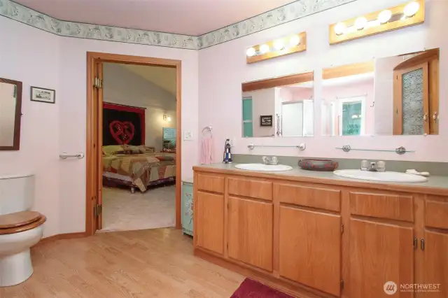 Long vanity in primary with double sinks, also a shower not showing.