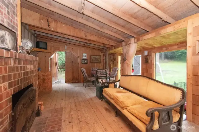 Enclosed back porch with wood burning fireplace.