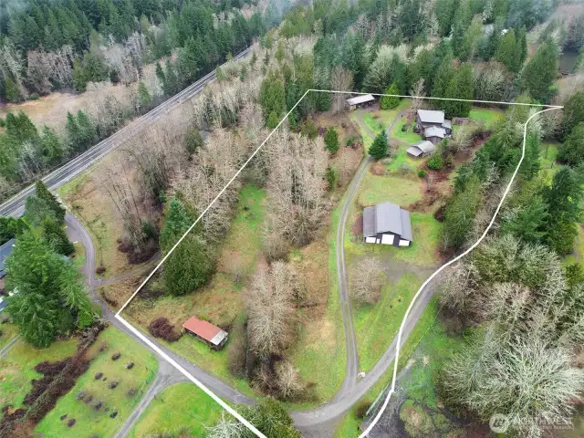 Drone view of land, showing small barn lower left corner .