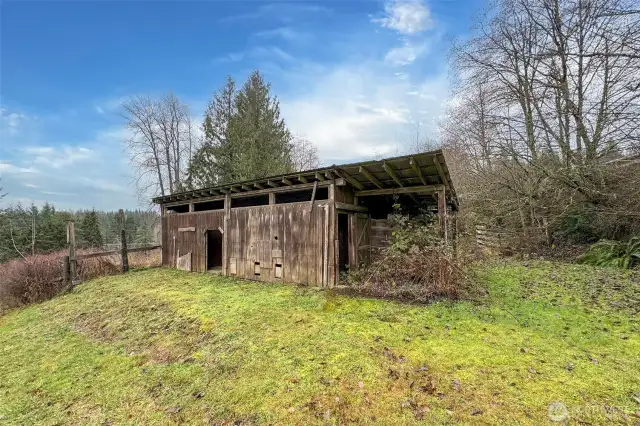 2 stall barn by road. with pasture going towards house and 2nd barn.