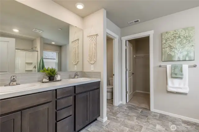 Primary bathroom includes dual sinks and walk-in closet