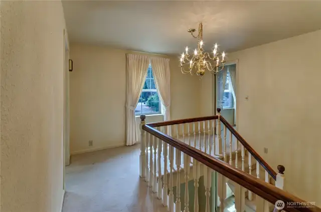 Upstairs landing, primary bedroom on right.