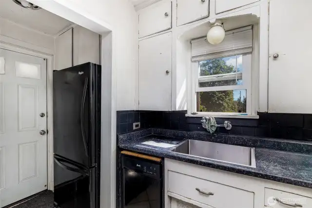 Kitchen features matching appliances and window above the sink.