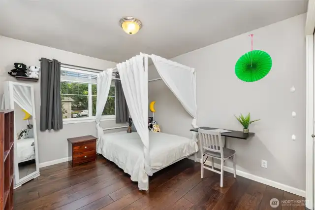 Bedroom across from main bath, with ample closet space and a large window.
