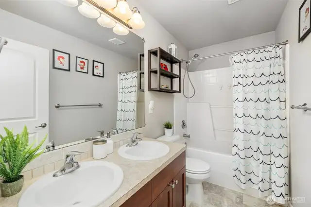 Double sinks in the main bath which is central to the bedrooms and right next to the laundry closet.