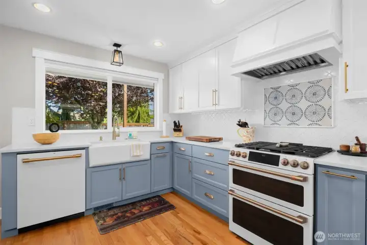 Stunning chef’s kitchen with farmhouse sink, gas range, and designer finishes