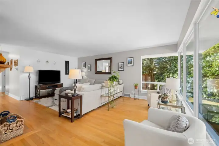 Spacious and inviting with oversized windows and gleaming hardwoods