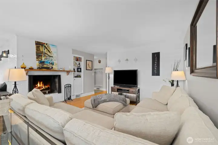 Classic wood-burning fireplace anchors the living room with warmth and charm
