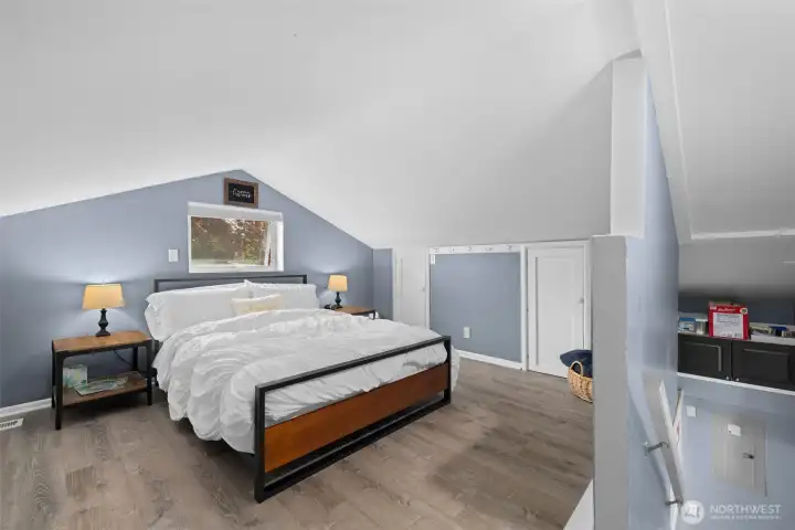 Stylish loft-style bonus room with vaulted ceilings and cozy feel