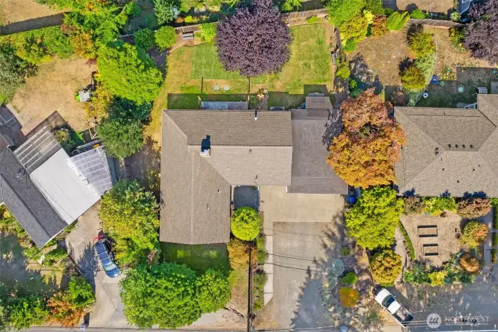 Large lot with landscaped yard, generous driveway, and oversized garage