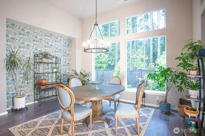 Dining area with a view of the backyard and the greenbelt beyond