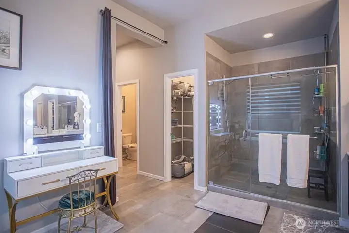 Primary bath with oversized shower and linen closet beyond