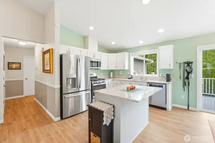 An open kitchen layout with generous counter space and a central island—designed for both cooking and conversation.