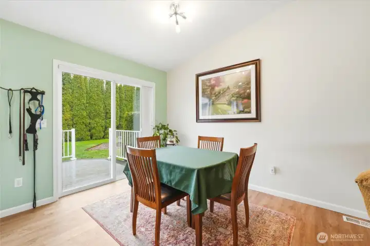 Positioned to take in backyard views, the dining area offers a warm setting for everyday meals and gatherings.