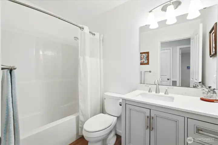 Fresh, functional, and roomy, twith clean finishes- the full bath off the hall is designed for ease of use and access.