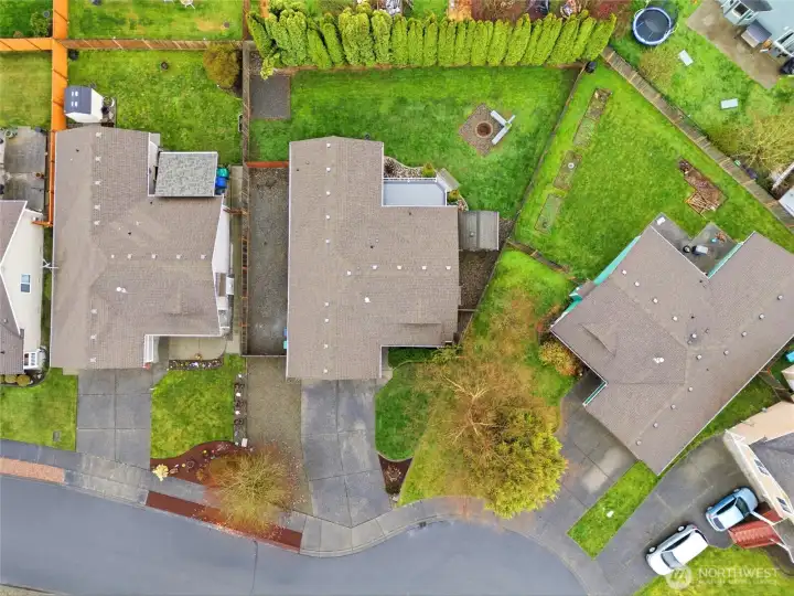 A large yard with mature trees, fully fenced backyard, long driveway with additional side yard parking- it's all there!