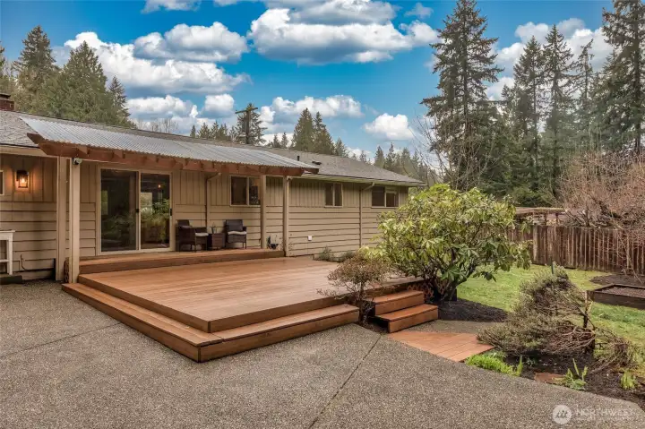 Covered patio area overlooking a large, serene backyard.