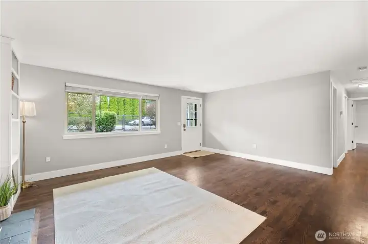The living room subtly transitions into the hallway where you will find the first bathroom.