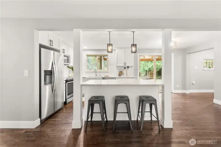 The island doubles as a breakfast bar, allowing for more seating and dining areas.