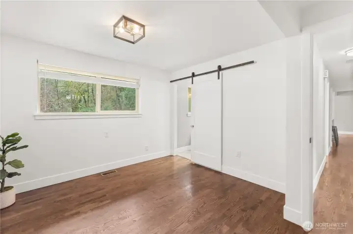 Primary Bedroom: Barn door to Primary Bathroom.
