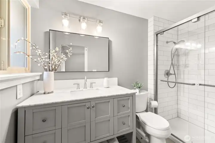 Primary Bathroom: featuring granite countertops and quality craftsmanship tile work.