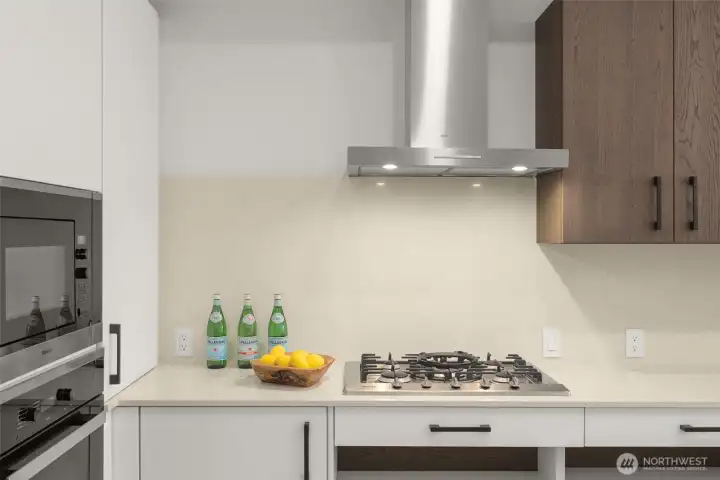 Miele appliances, quartz countertops, gas range and ADA Custom Cabinetry