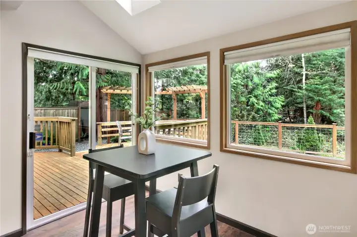 Eating nook looks out onto private, woodsy backyard and greenbelt