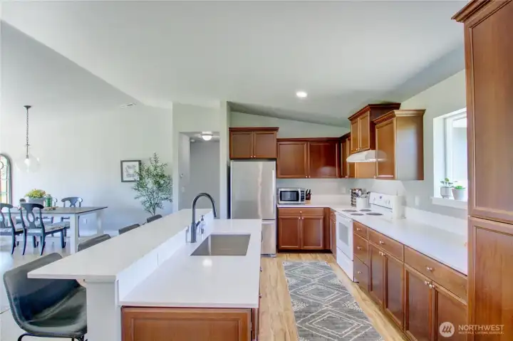 Loads of cabinets, new quartz counters, new sink, faucet and new flooring.