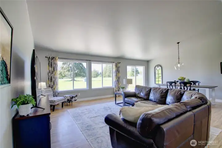 Open concept is spacious feeling with the vaulted ceiling.  Access to back patio off of dining room.  Peaceful westerly views across the acreage.