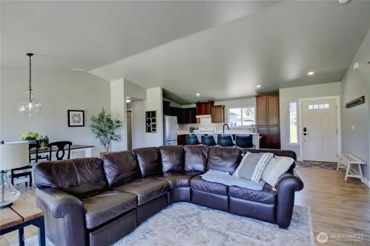 Living room looking towards kitchen, laundry room and primary bedroom to the left.
