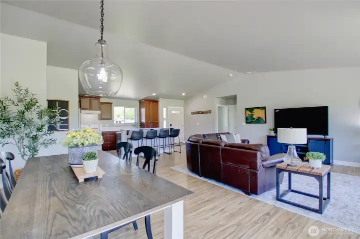 Looking from dining area towards front entrance and 2 bedrooms, full bathroom to the right.