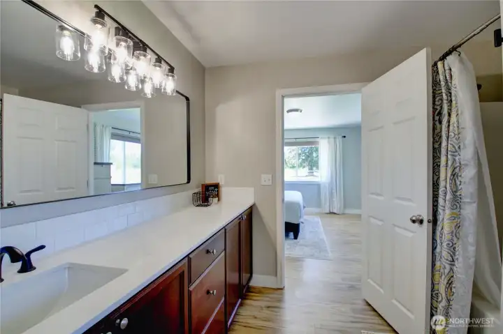 Primary bathroom with great counter space and new quartz counter & plumbing fixtures.