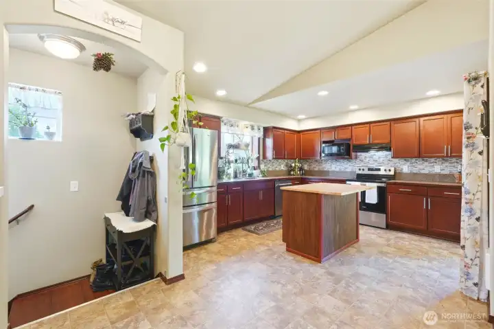 Vaulted ceilings, open floor plan easy access to rear yard via sliding room to a covered rear deck. All appliances convey. It's an entertainers dream.