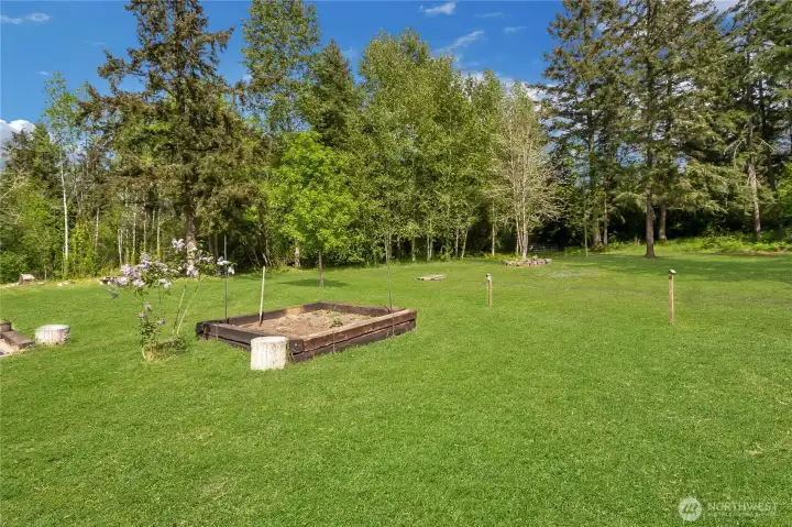 Compost bin, herb garden, wooded setting.  Drainage seasonal creek or ditch, drys up every year in summer.