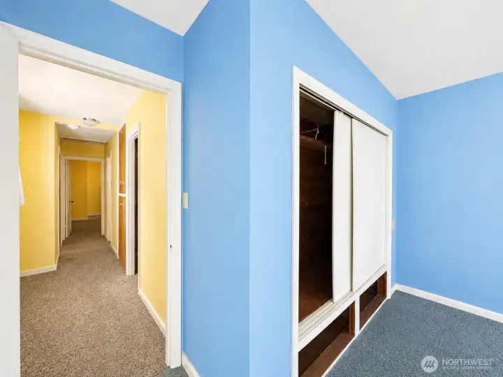 Third bedroom view into hallway, hardwood floors under carpet