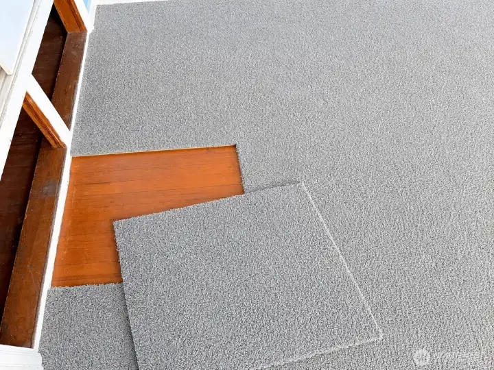 Third bedroom hardwood floors under carpet squares