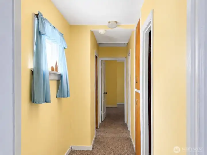 Main hallway from third bedroom, built in storage, window and oversized