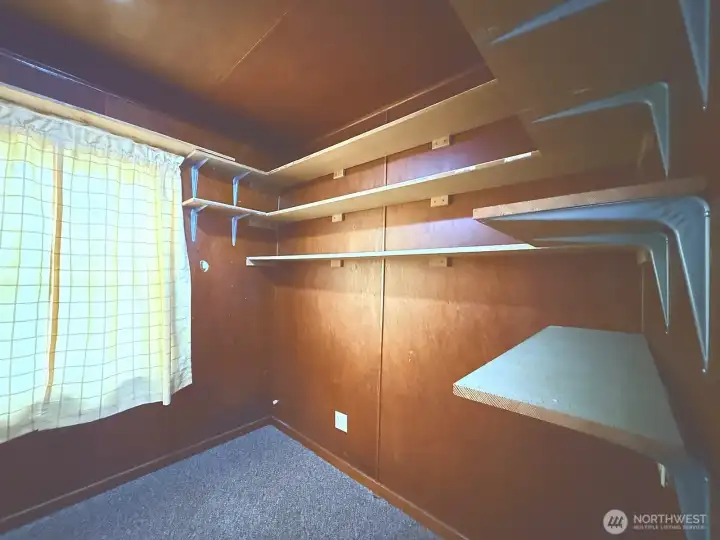 Bedroom currently lined with storage shelving