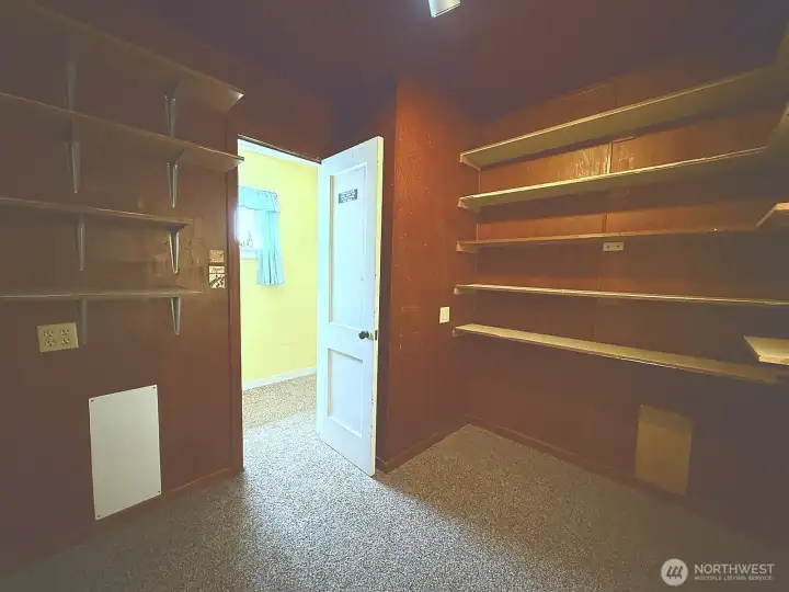 Bedroom currently lined with storage shelving