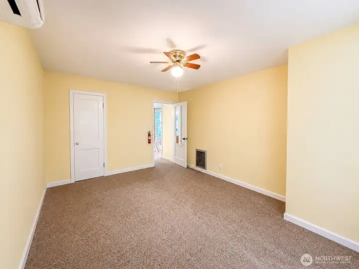 Primary bedroom is light and bright, ceiling fan, mini split