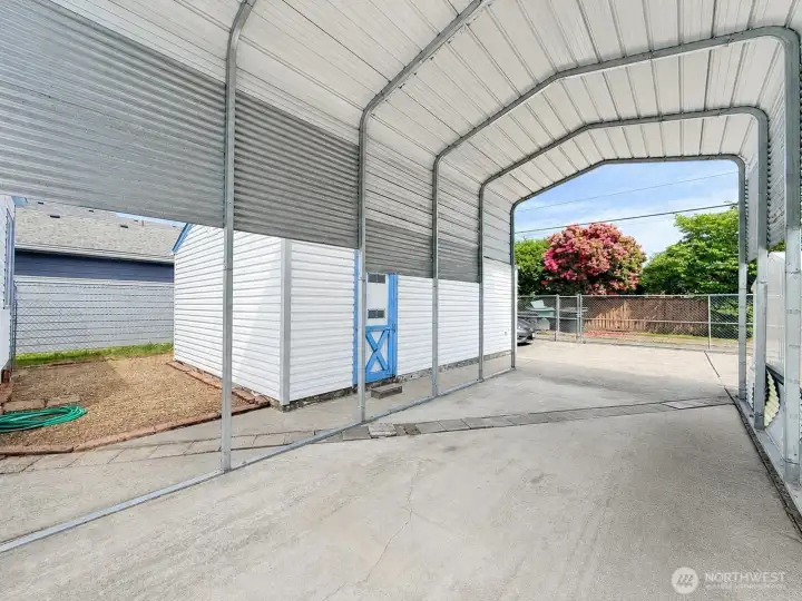 Covered RV parking with alley access, fully fenced backyard