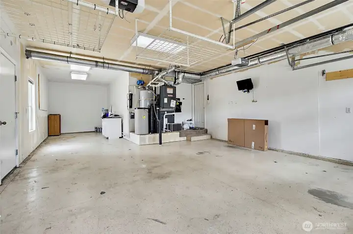 Spacious three-car tandem garage providing ample room for vehicles and extra storage.