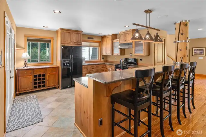 BIG cabin kitchen features tiled floors &  an eating bar.