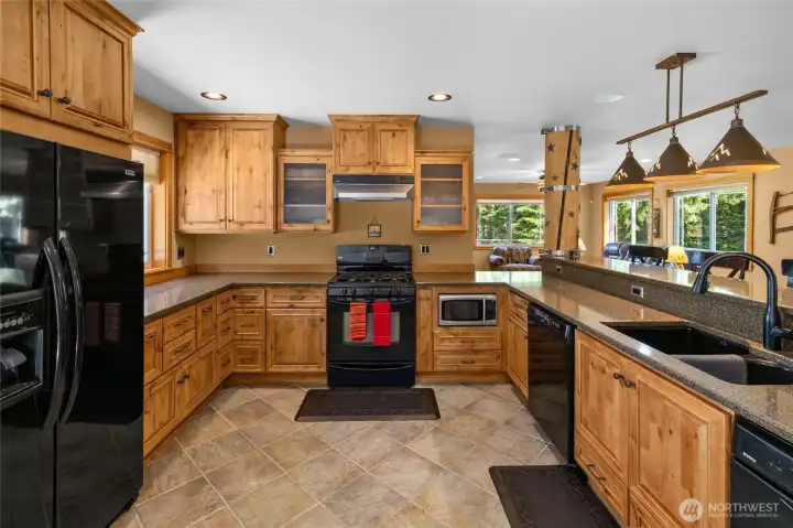 This custom kitchen has some hidden treasures, like spice rack & pull out corner cabinets!