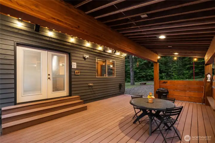 Let's go outside! The spacious back deck is Trex and conveniently located off of the kitchen & has outdoor speakers.