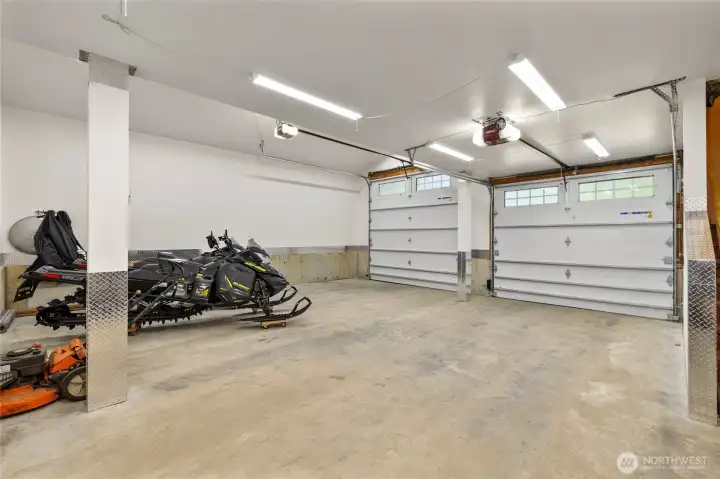 Attached garage has concrete floors, a work bench & fuel storage.